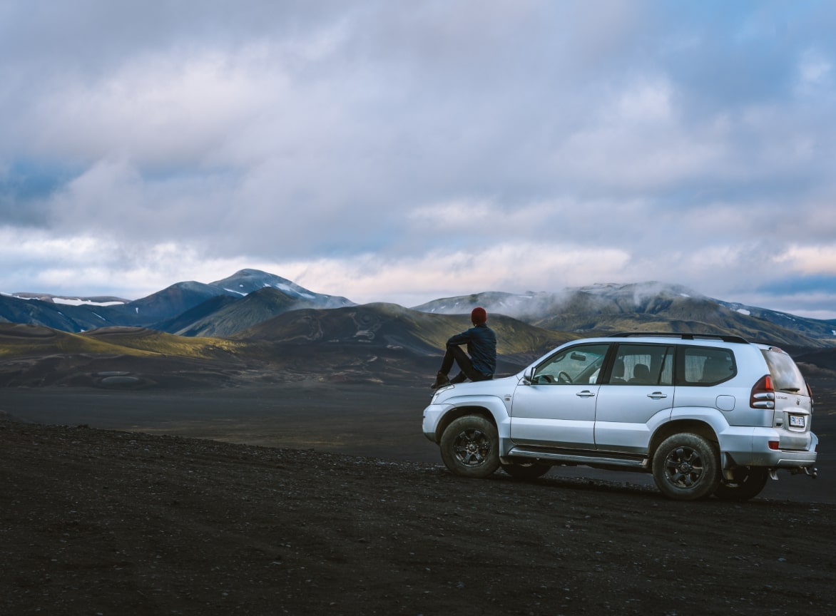 pexels-simon-migaj-1571783@2x man sitting on car