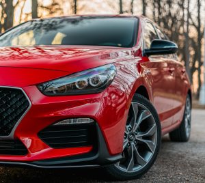 adam-stefanca-hdMSxGizchk-unsplash2 Close Image of Red Car Parked
