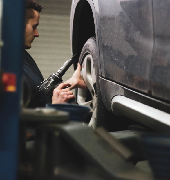 benjamin-brunner-_kvdYDxvnCo-unsplash Employee Working on a Car Wheel