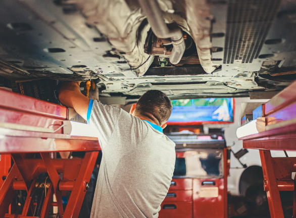 enis-yavuz-tZtgozUpZZc-unsplash Person Doing Mechanic Work Under a Car
