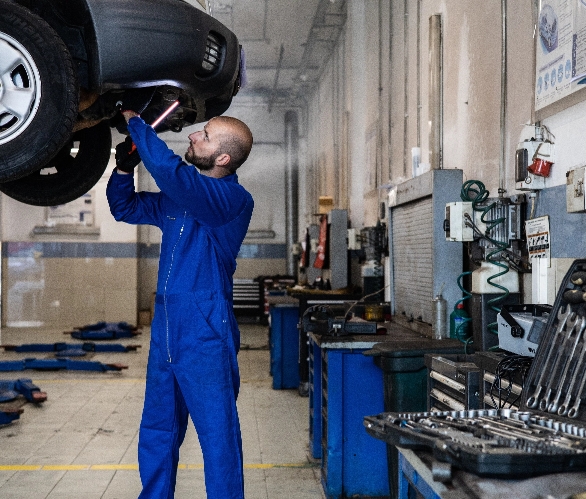 pexels-artem-podrez-8986148 Mechanic working under a car